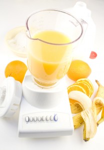Blender with fruit, ice and milk to make smotthies