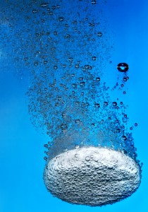 Effervescent tablet in water with bubbles...